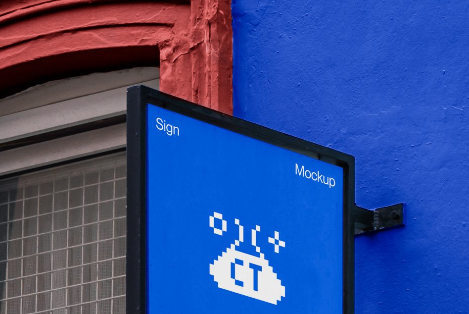Bright blue wall sign mockup with pixel art logo between red building